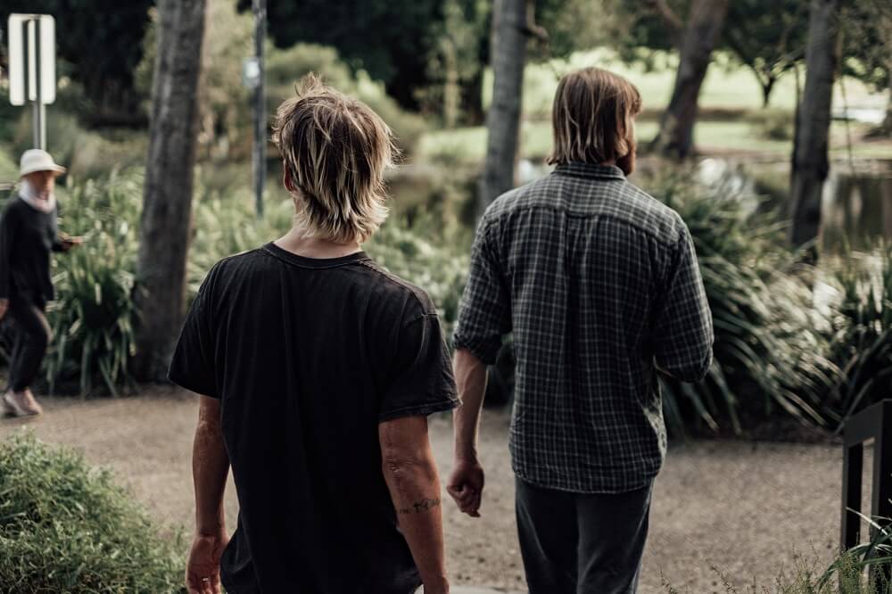 Two men walking in a park