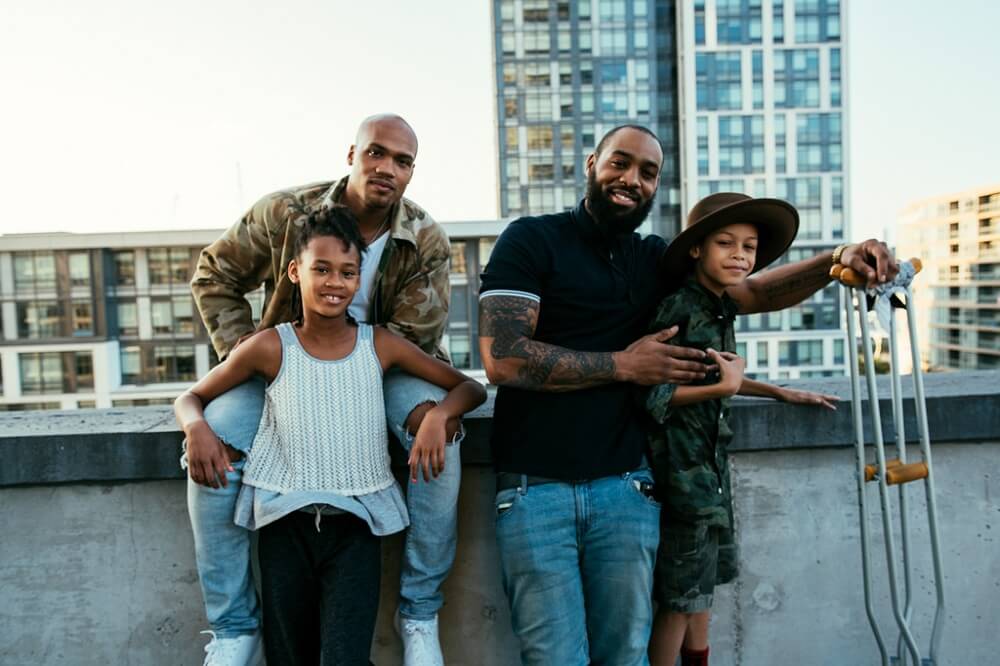 Men of colour with their kids looking out for each others mental health 