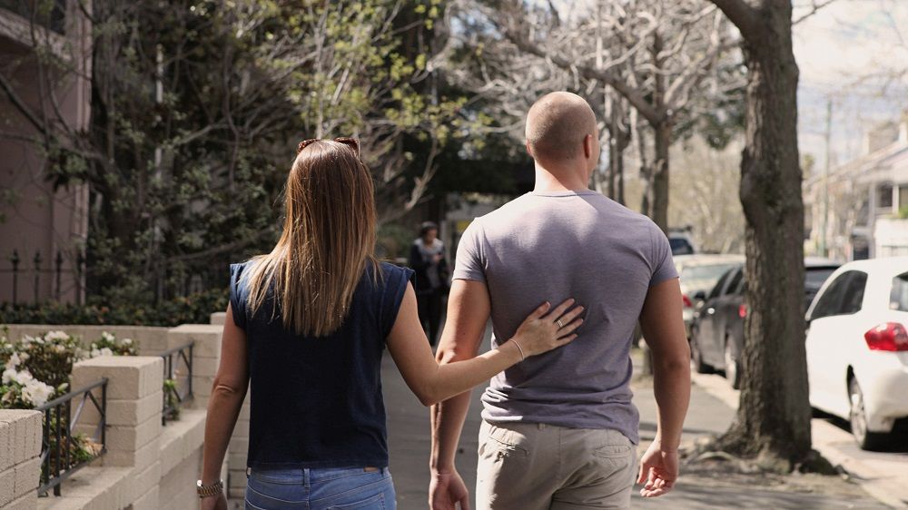  Woman walking with a man who she's concerned is burning out