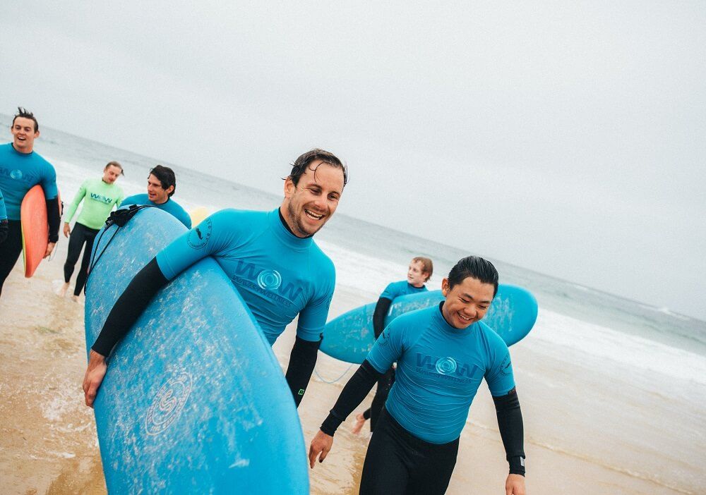 A group of men surfing and checking in on each other 